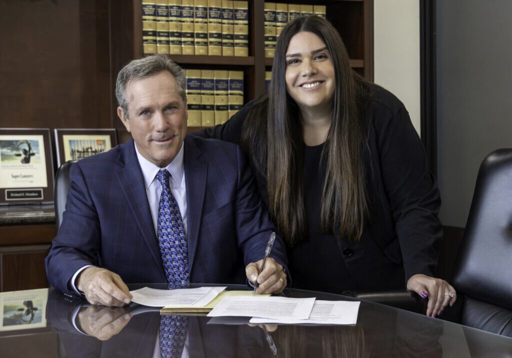 William Donahoo and Sarah L. Kokonas working at their office conference table.