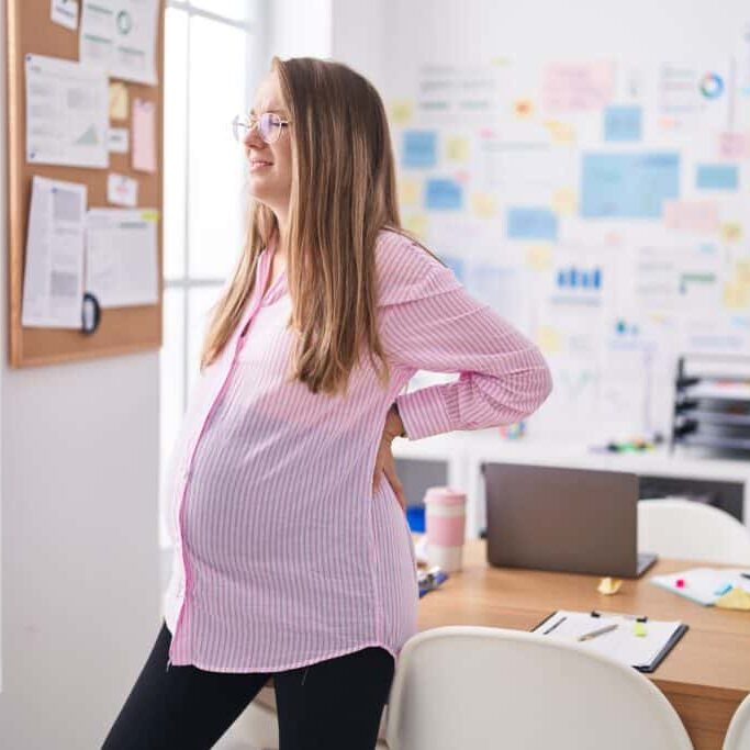 Young Pregnant Woman Business Worker Suffering For Backache At Office